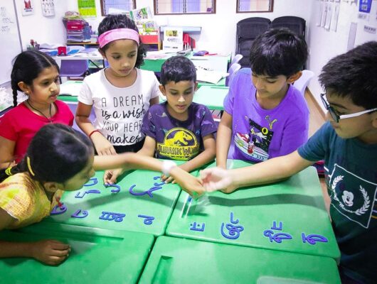 Students learning Tamil alphabets Students learning Tamil alphabets