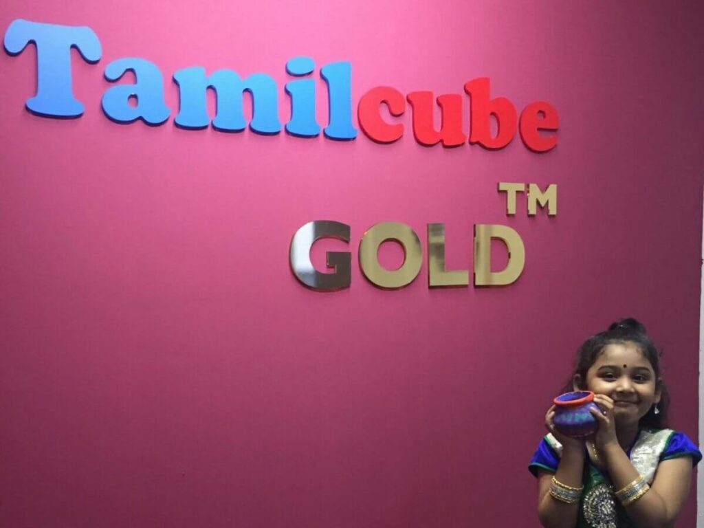 Tamil tuition - A happy student with a painted pot at Tamilcube learning centre