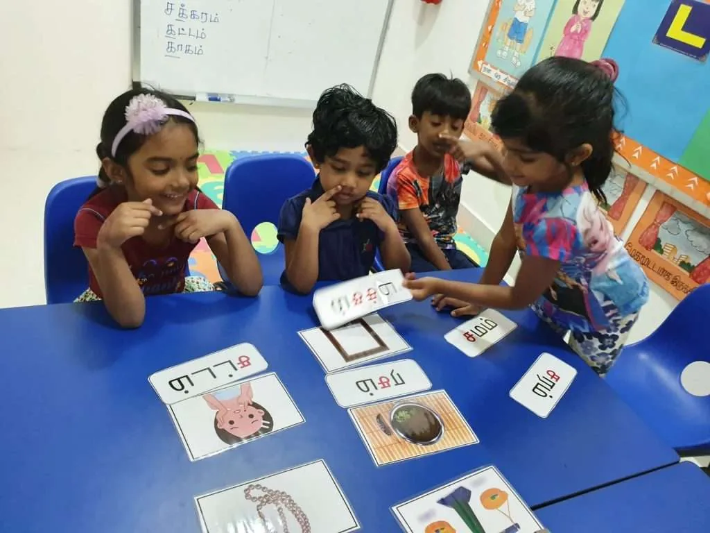 Students participating in a fun, game-based Tamil tuition lesson at Tamilcube.